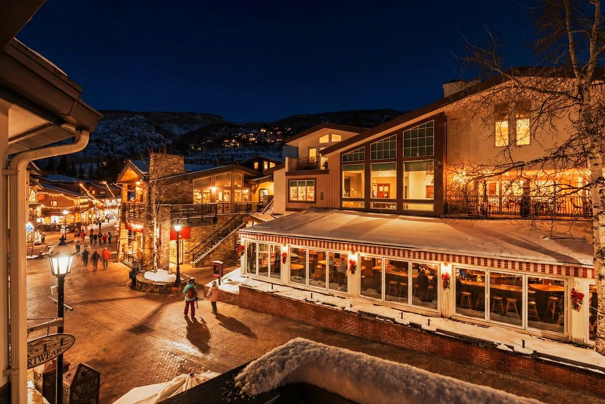Vail Village at blue hour, lit shopfronts along the pedestrian street